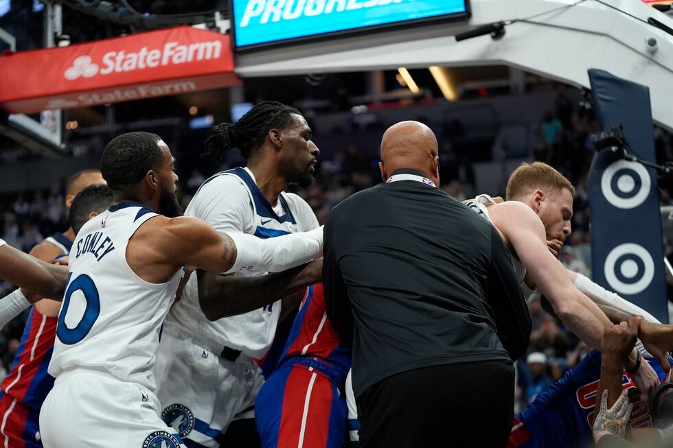 Minnesota Timberwolves and Detroit Pistons players get into a fight during the first half of...