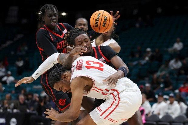 SDSU's BJ Davis and Houston's J'Wan Roberts (13) fight for a rebound in the Aztecs' 73-70 overtime win Saturday in Las Vegas. (AP Photo/Ian Maule)