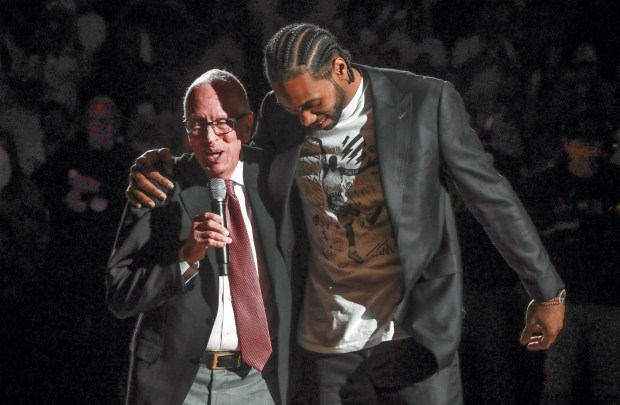 Clippers star and former San Diego State basketball player Kawhi Leonard puts his arm around former Aztecs basketball coach Steve Fisher during a halftime ceremony to retire Leonard's jersey at the Viejas Arena on Saturday, Feb. 1, 2020 in San Diego, California.