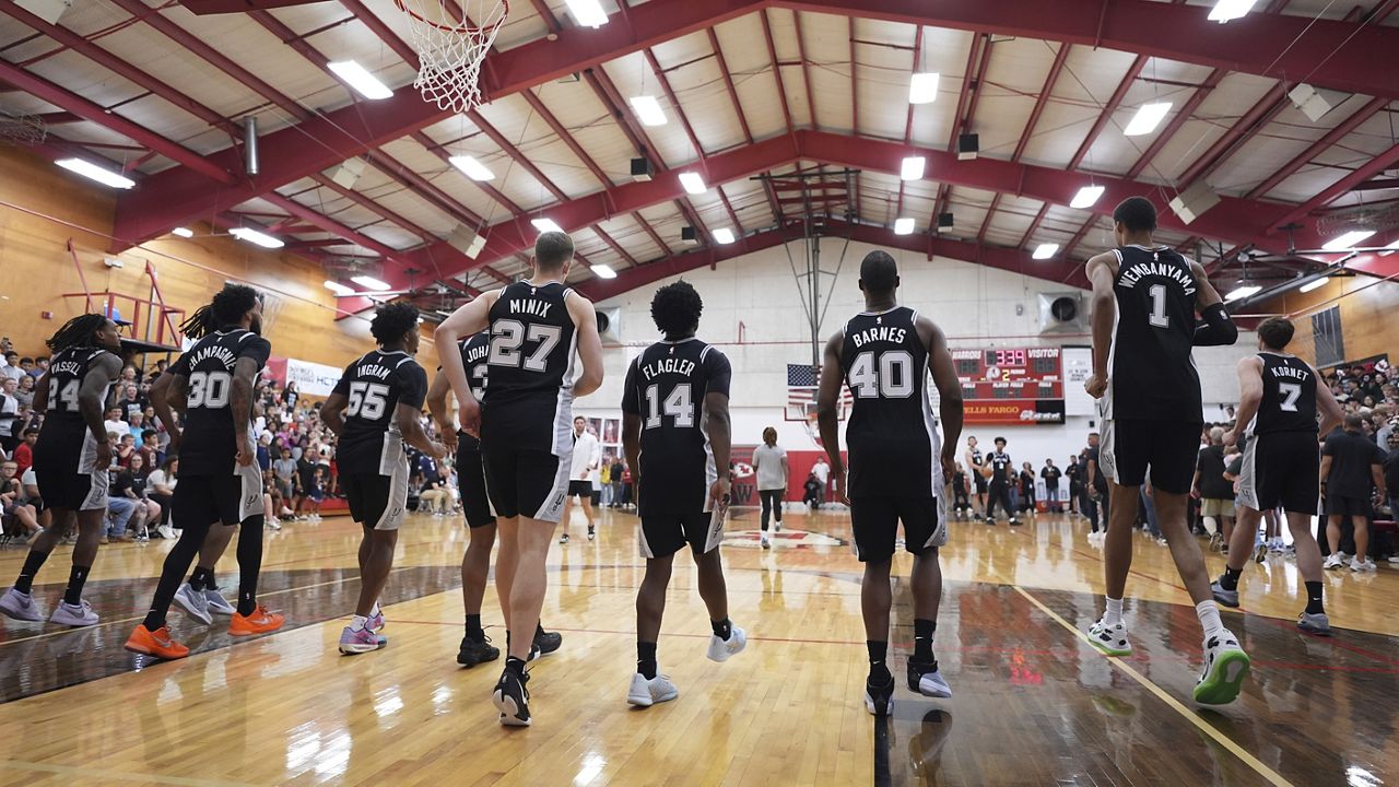 San Antonio Spurs players make a surprise visit to Tom Moore High School in Ingram, Texas, to visit the students and families of those impacted by flooding that killed more than 130 people across the region,Wednesday, Sept. 10, 2025. (AP Photo/Eric Gay)