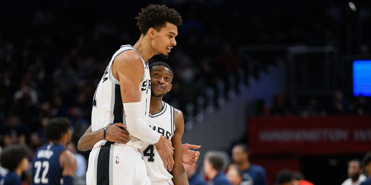 Spurs center Victor Wembanyama (1) and guard De'Aaron Fox (4) react during the second quarter against the Washington Wizards at Capital One Arena