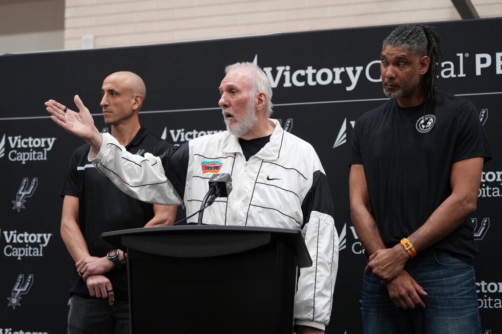With the help of former players Manu Ginobili, left, and Tim Duncan, right, former San Antonio...