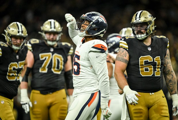 Nik Bonitto (15) of the Denver Broncos celebrates sacking Spencer Rattler (18) of the New Orleans Saints in front of Landon Young (67), Trevor Penning (70) and Connor McGovern (61) of the New Orleans Saints during the second half of the Broncos' 33-10 win at Caesars Superdome in New Orleans, Louisiana on Thursday, Oct. 17, 2024. (Photo by AAron Ontiveroz/The Denver Post)