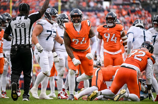 Eyioma Uwazurike (96) of the Denver Broncos celebrates stopping Tony...
