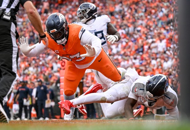 D.J. Jones (93) of the Denver Broncos knocks down Cam...