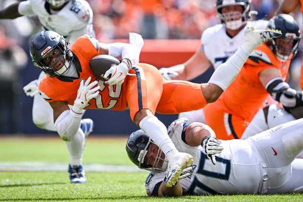 Brandon Jones (22) of the Denver Broncos recovers a fumble...