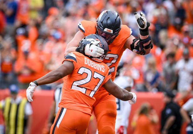 J.K. Dobbins (27) of the Denver Broncos celebrates his rushing...