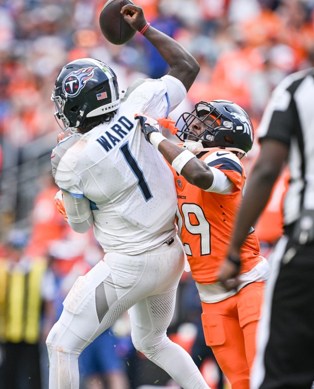 Ja'Quan McMillian (29) of the Denver Broncos sacks Cam Ward...