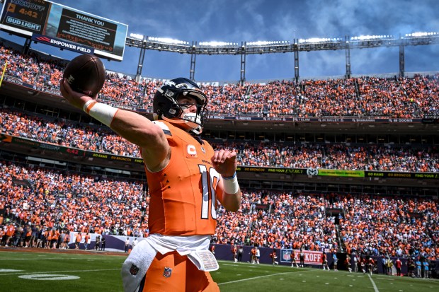 Bo Nix (10) of the Denver Broncos warms up during...