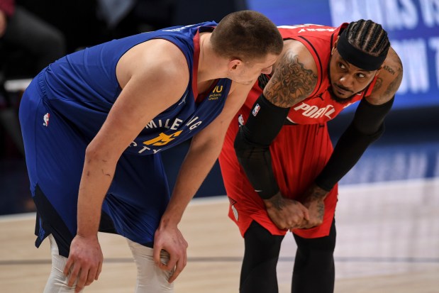 Nikola Jokic (15) of the Denver Nuggets and Carmelo Anthony (00) of the Portland Trail Blazers exchange friendly banter during a fourth quarter that would close at 121-121 to force overtime at Ball Arena on Tuesday, June 1, 2021. (Photo by AAron Ontiveroz/The Denver Post)