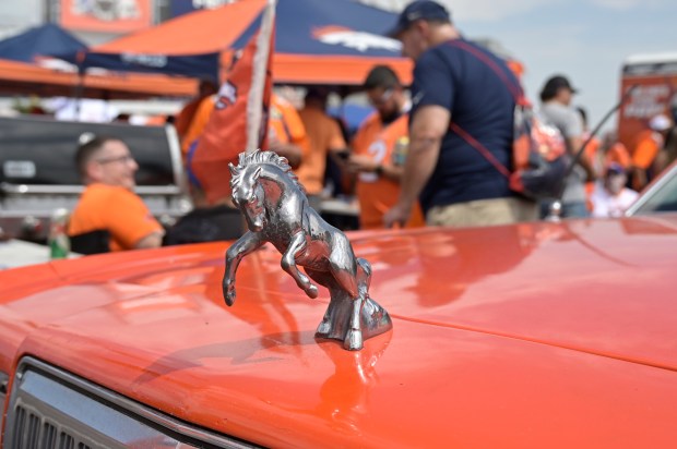 A Denver Broncos hood orniment on a limo outside Empower...