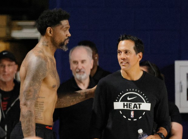 Miami Heat head coach Erik Spoelstra and Udonis Haslem are...