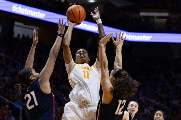 Tennessee forward Zee Spearman (11) shoots over UConn forward Sarah Strong (21) and guard Ashlynn Shade (12) during the second half of an NCAA college basketball game Thursday, Feb. 6, 2025, in Knoxville, Tenn. (AP Photo/Wade Payne)