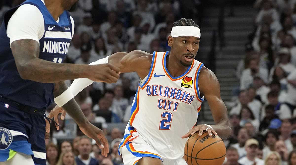 Thunder guard Shai Gilgeous-Alexander (2) dribbles the ball past Minnesota Timberwolves center Naz Reid (11) in the first half during game four of the western conference finals for the 2025 NBA Playoffs at Target Center