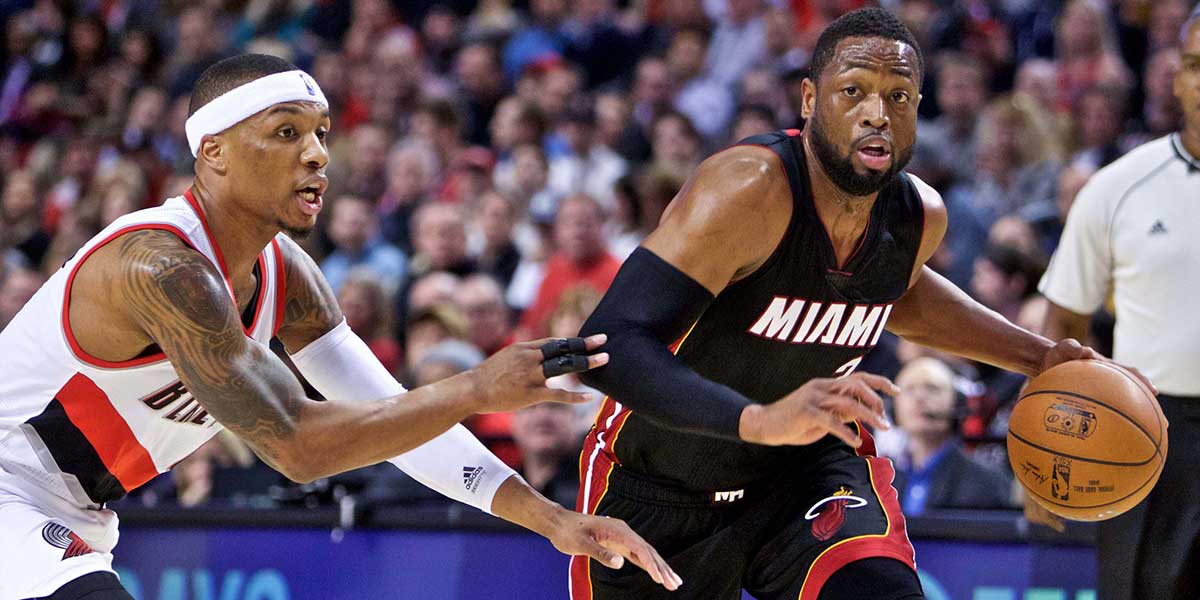 Heat guard Dwyane Wade (3) drives past Portland Trail Blazers guard Damian Lillard (0) during the first quarter at the Moda Center