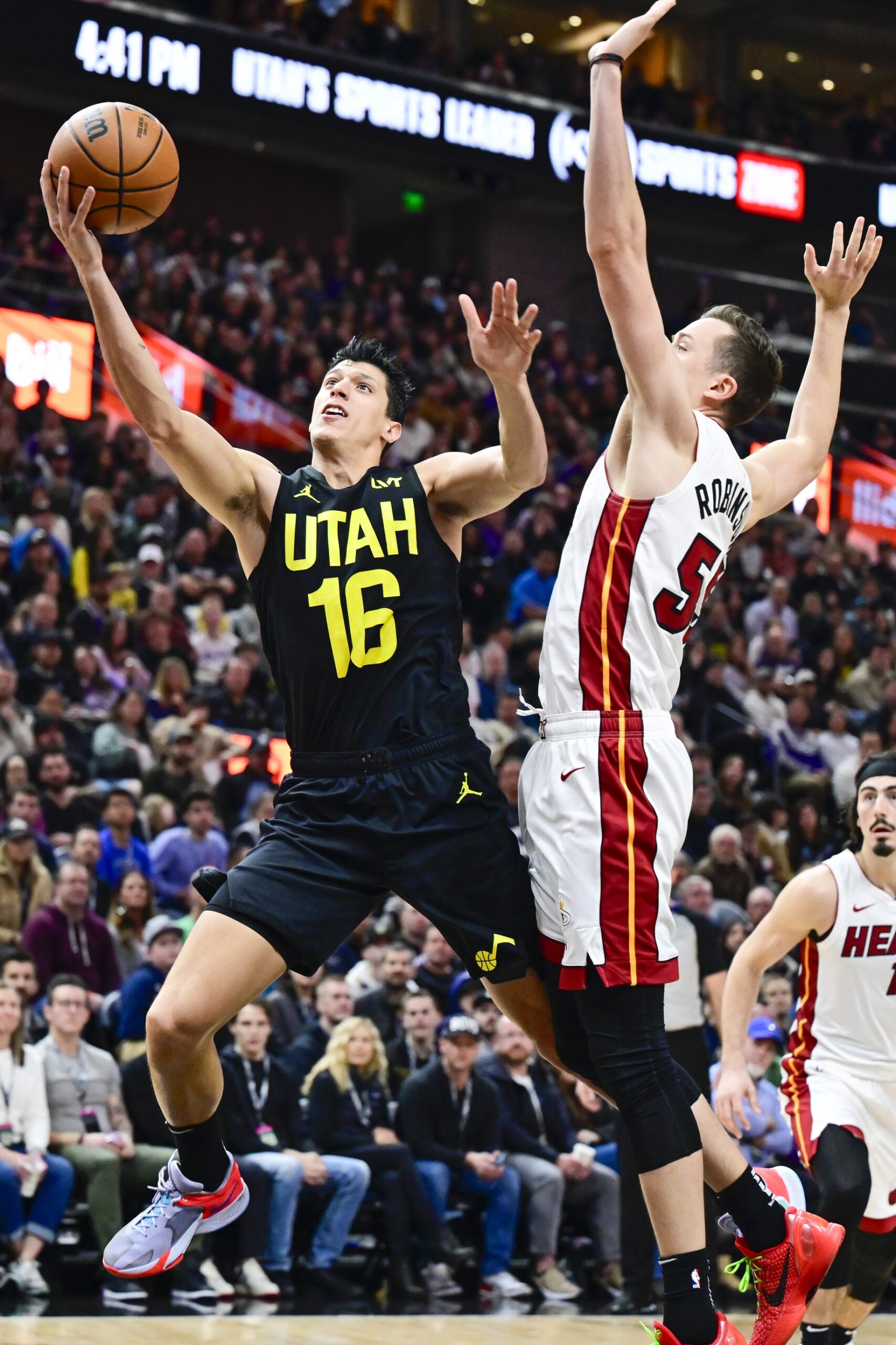 Utah Jazz forward Simone Fontecchio (16) takes a layup around Miami Heat forward Duncan Robinson (55) during the second half at Vivint Arena.