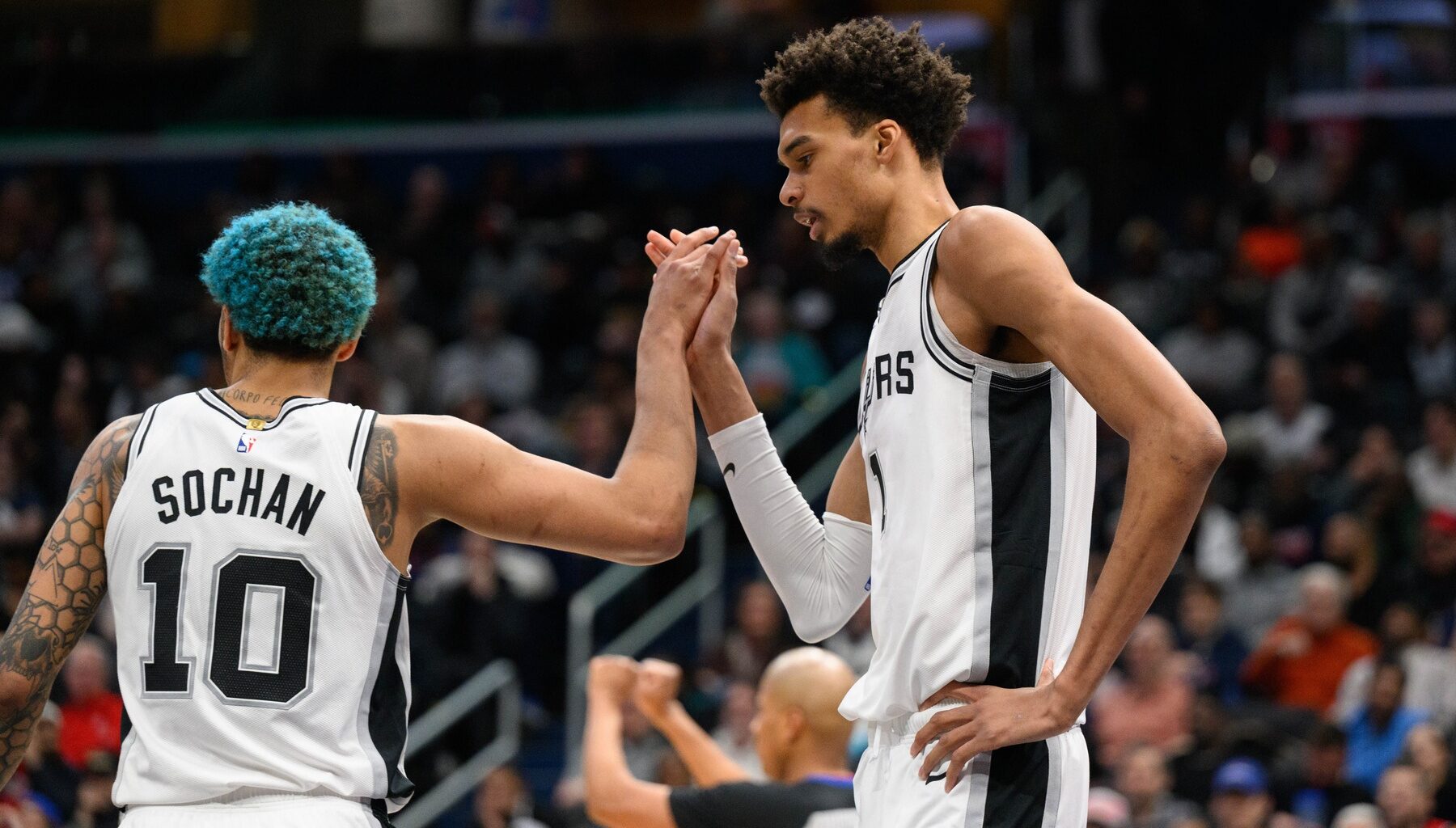 Feb 10, 2025; Washington, District of Columbia, USA; San Antonio Spurs center Victor Wembanyama (1) and San Antonio Spurs forward Jeremy Sochan (10) reacts during the fourth quarter against the Washington Wizards at Capital One Arena. Mandatory Credit: Reggie Hildred-Imagn Images