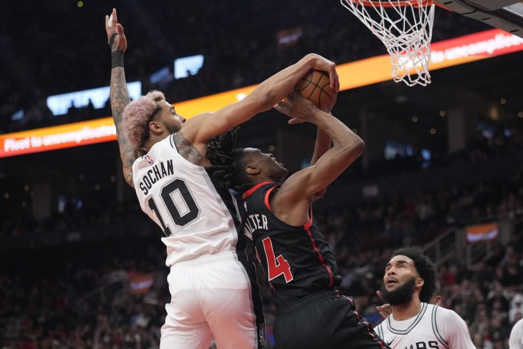 Mar 23, 2025; Toronto, Ontario, CAN; San Antonio Spurs forward Jeremy Sochan (10) blocks a shot attempt by Toronto Raptors guard Ja'Kobe Walter (14) during the first half at Scotiabank Arena. Mandatory Credit: John E. Sokolowski-Imagn Images
