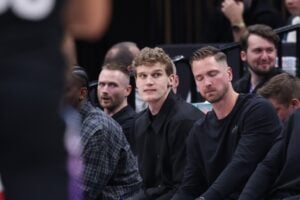 Utah Jazz forward Lauri Markkanen (center) watches the game from the bench during the second half of the game against the Houston Rockets at Delta Center.
