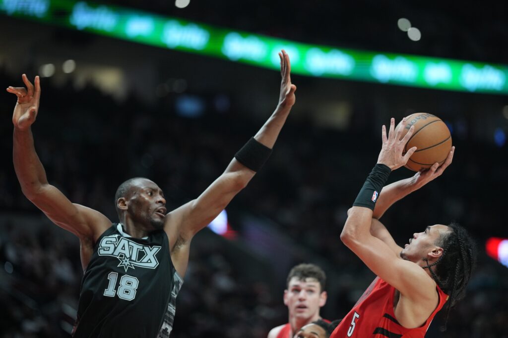 Apr 6, 2025; Portland, Oregon, USA; Portland Trail Blazers guard Dalano Banton (5) shoots over San Antonio Spurs center Bismack Biyombo (18) during the second half at Moda Center. Mandatory Credit: Soobum Im-Imagn Images
