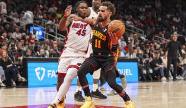 Apr 18, 2025; Atlanta, Georgia, USA; Atlanta Hawks guard Trae Young (11) tries to get to the basket against Miami Heat guard Davion Mitchell (45) during the first half at State Farm Arena. Mandatory Credit: Dale Zanine-Imagn Images
