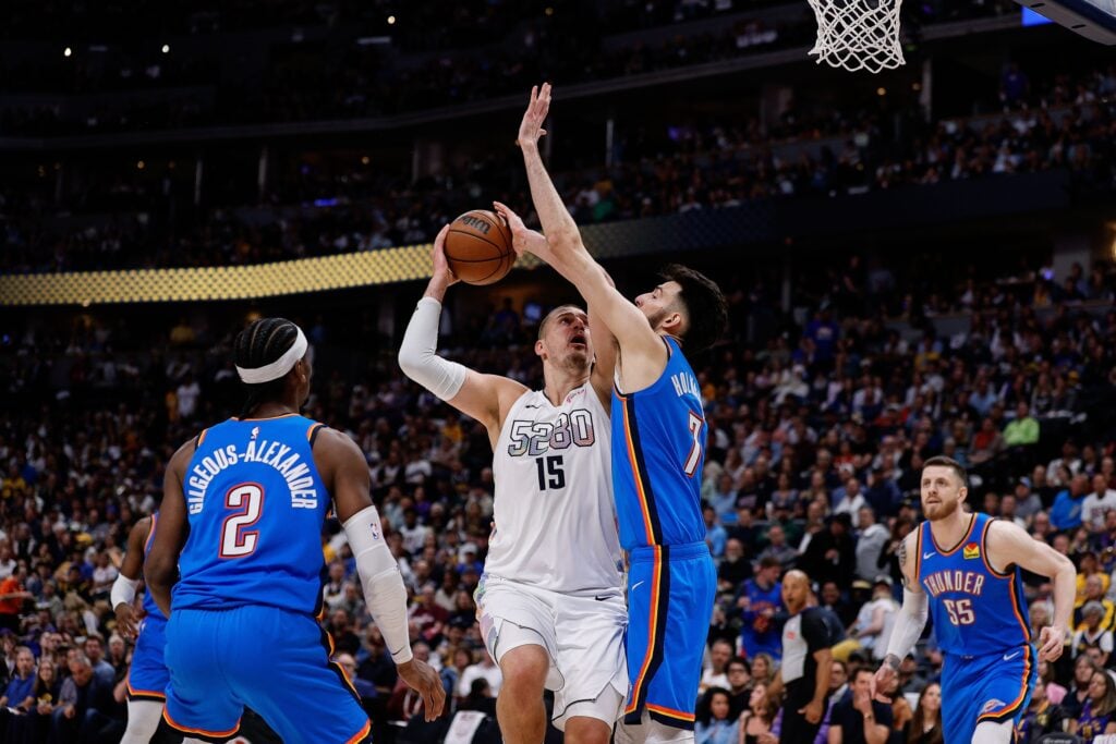 May 15, 2025; Denver, Colorado, USA; Denver Nuggets center Nikola Jokic (15) drives to the net against Oklahoma City Thunder forward Chet Holmgren (7) as guard Shai Gilgeous-Alexander (2) defends in the third quarter during game six of the second round for the 2025 NBA Playoffs at Ball Arena. Mandatory Credit: Isaiah J. Downing-Imagn Images