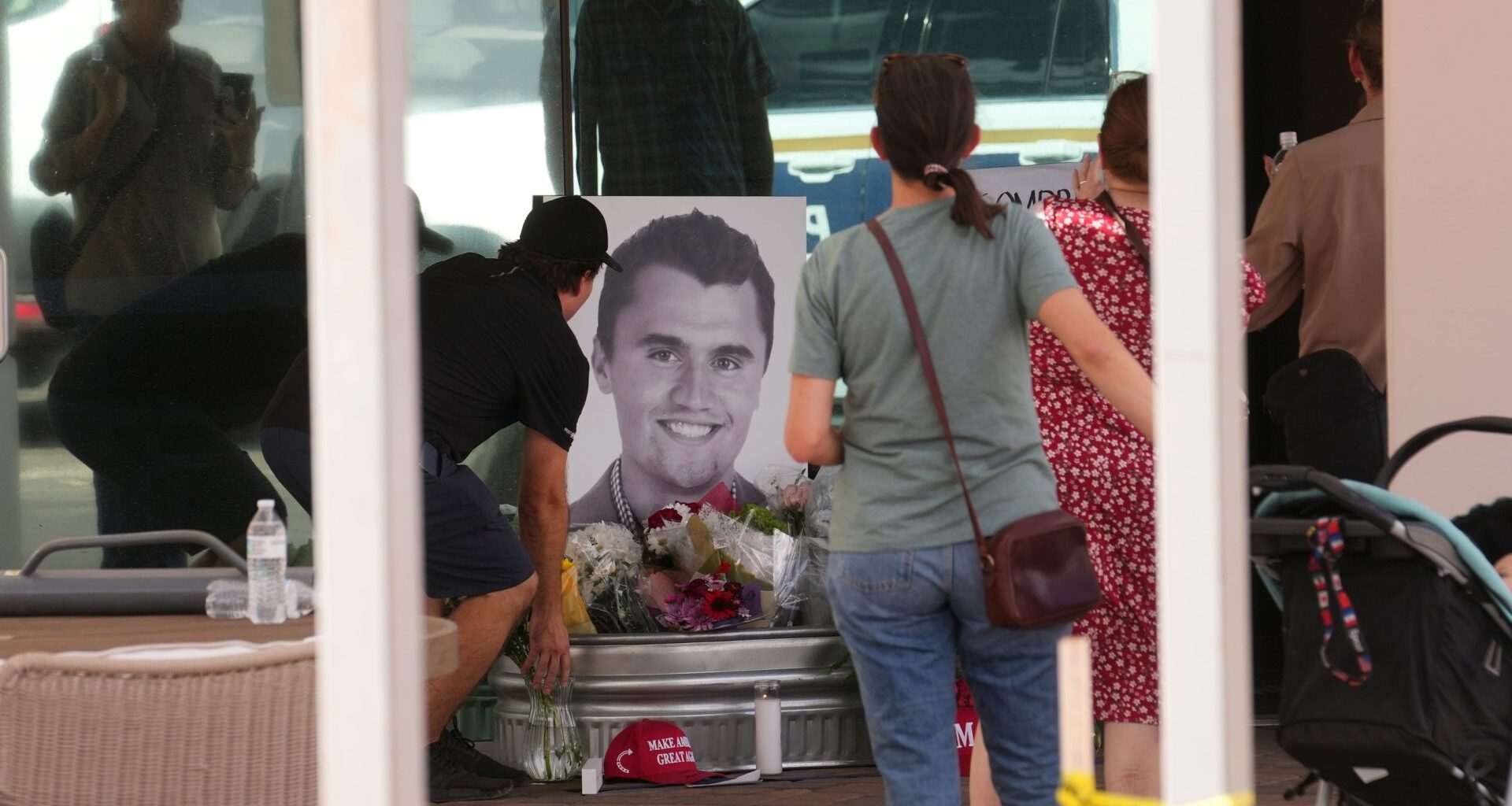 People congregate at Turning Point Headquarters in Phoenix after news that the founder, Charlie Kirk, was shot and killed at a rally in Utah on Sept. 10, 2025.