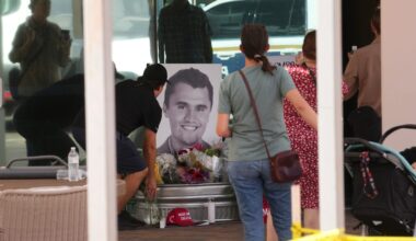 People congregate at Turning Point Headquarters in Phoenix after news that the founder, Charlie Kirk, was shot and killed at a rally in Utah on Sept. 10, 2025.