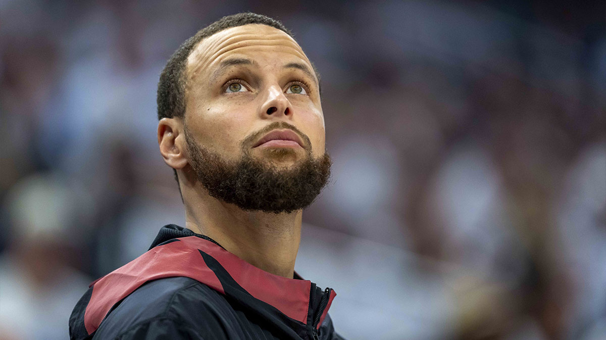 Warriors guard Stephen Curry (30) looks on from the bench against the Minnesota Timberwolves in the second half during game two of the second round for the 2025 NBA Playoffs at Target Center