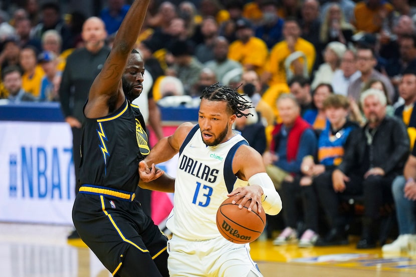 Dallas Mavericks guard Jalen Brunson (13) tries to drive around Golden State Warriors...