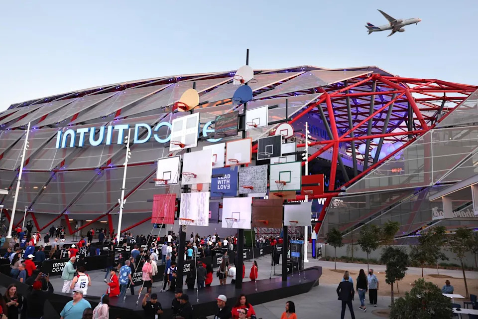 A plane flies over the Intuit Dome in Inglewood.