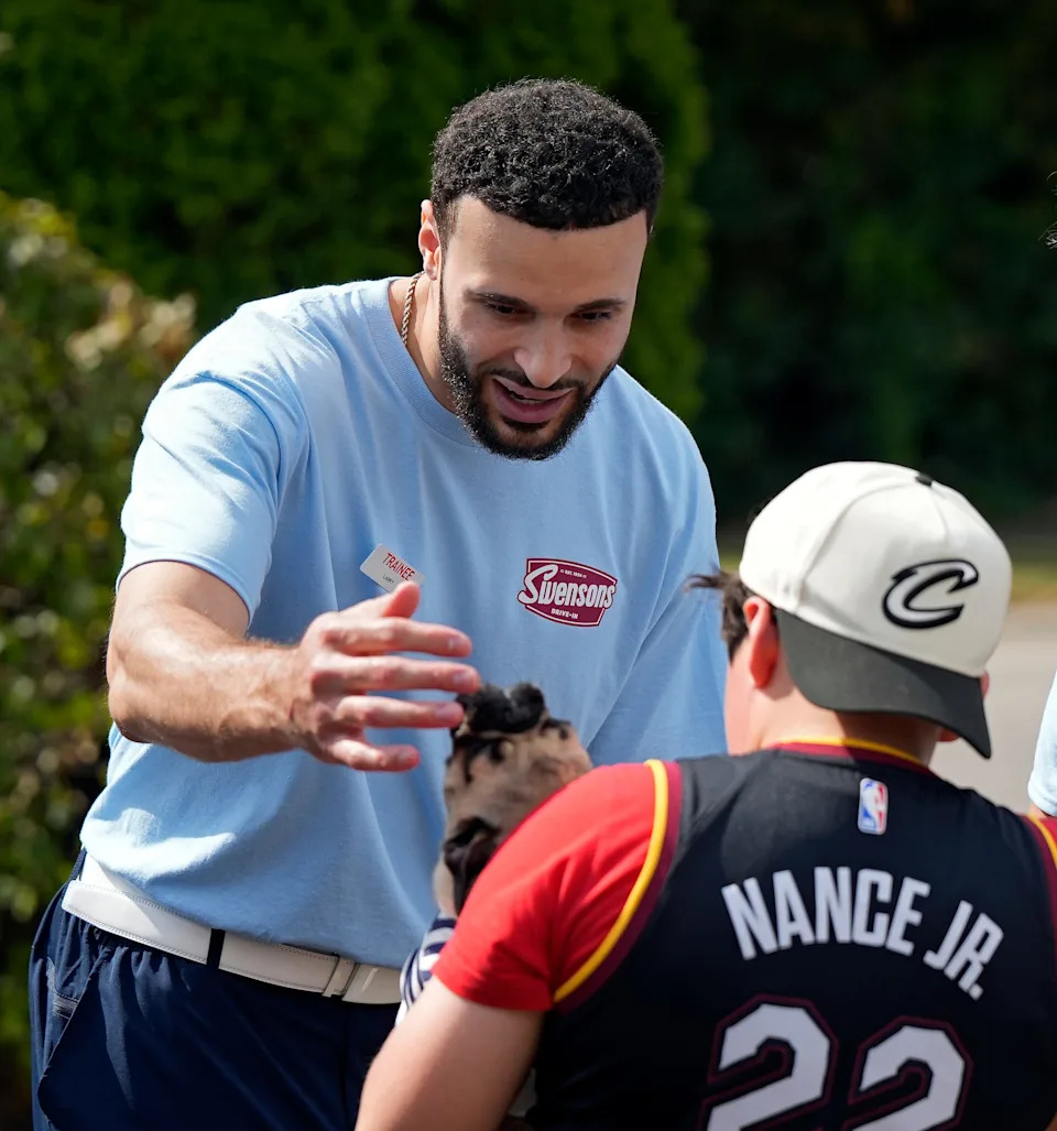 Larry Nance Jr. greets Mason Brosch and his dog Argyle during a fundraising event at the Swensons Drive-In on Hawkins Ave., Sept. 13, 2025, in Akron, Ohio.