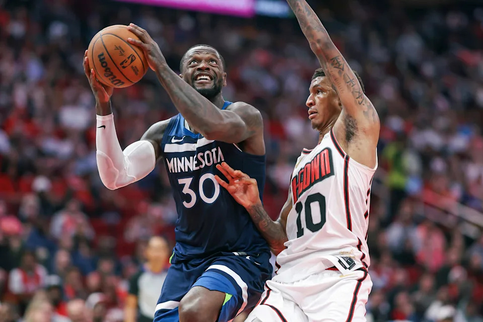 Dec 27, 2024; Houston, Texas, USA; Minnesota Timberwolves forward Julius Randle (30) attempts to score as Houston Rockets forward Jabari Smith Jr. (10) defends during the second quarter at Toyota Center. Mandatory Credit: Troy Taormina-Imagn Images