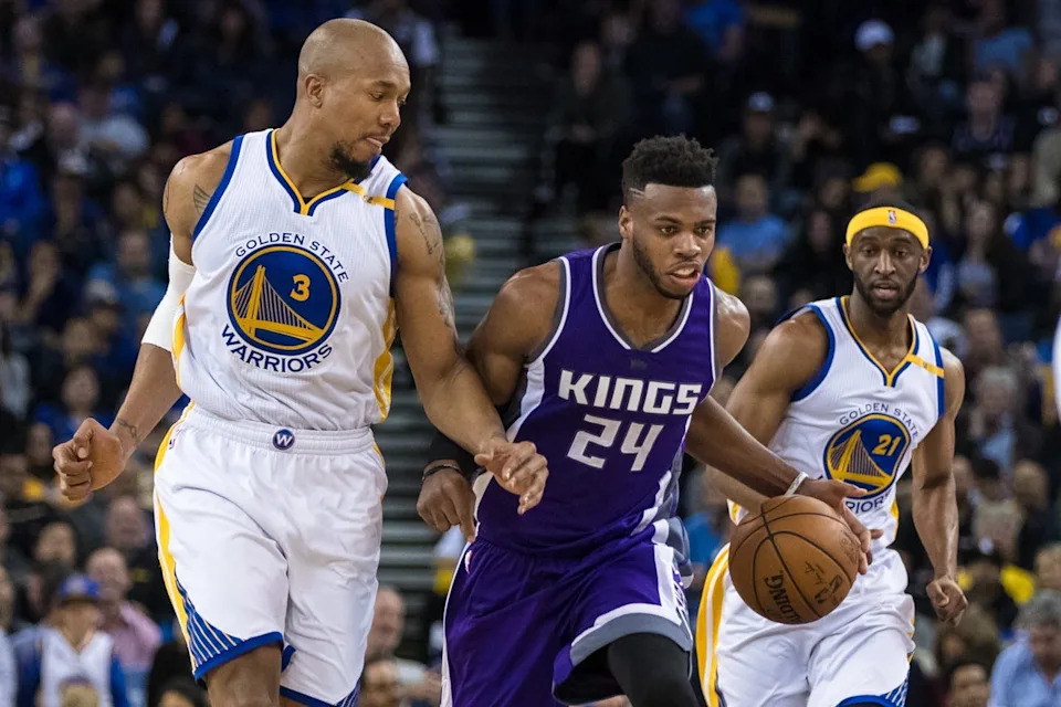 Mar 24, 2017; Oakland, CA, USA; Sacramento Kings guard Buddy Hield (24) dribbles as Golden State Warriors forward David West (3) and guard Ian Clark (21) defend in the fourth quarter at Oracle Arena. The Warriors won 114-100. Mandatory Credit: John Hefti-USA TODAY Sports