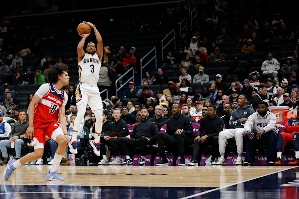 Jan 5, 2025; Washington, District of Columbia, USA; New Orleans Pelicans guard CJ McCollum (3) shoots the ball over Washington Wizards forward Kyshawn George (18) in the fourth quarter at Capital One Arena. Mandatory Credit: Geoff Burke-Imagn Images
