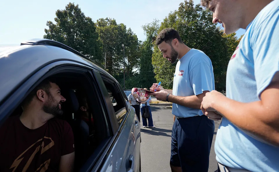 Cleveland Cavaliers’ Larry Nance Jr. signs autographs for Dylan Ulis and his son Carter of Wadsworth at the Swensons Drive-In on Hawkins Ave., Sept. 13, 2025, in Akron, Ohio.