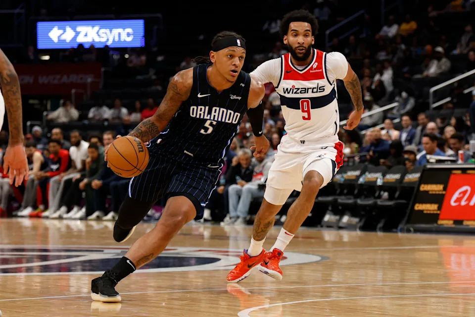 Apr 3, 2025; Washington, District of Columbia, USA; Orlando Magic forward Paolo Banchero (5) drives to the basket as Washington Wizards forward Justin Champagnie (9) chases in the first half at Capital One Arena. Mandatory Credit: Geoff Burke-Imagn Images