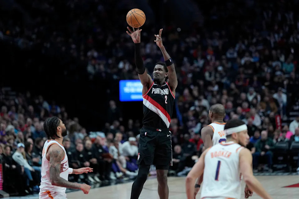 Feb 1, 2025; Portland, Oregon, USA; Portland Trail Blazers center Deandre Ayton (2, left) shoots the ball over Phoenix Suns center Nick Richards (2) during the second half at Moda Center. Mandatory Credit: Soobum Im-Imagn Images