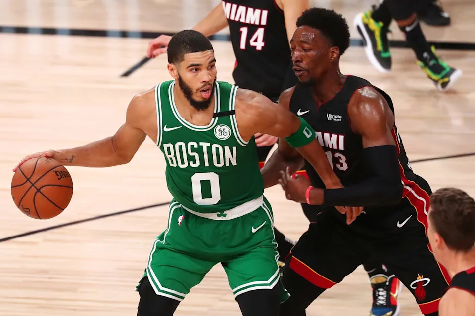 Sep 19, 2020; Lake Buena Vista, Florida, USA; Boston Celtics forward Jayson Tatum (0) dribbles the ball against Miami Heat forward Bam Adebayo (13) during the second half of game three of the Eastern Conference Finals of the 2020 NBA Playoffs at ESPN Wide World of Sports Complex. Mandatory Credit: Kim Klement-USA TODAY Sports
