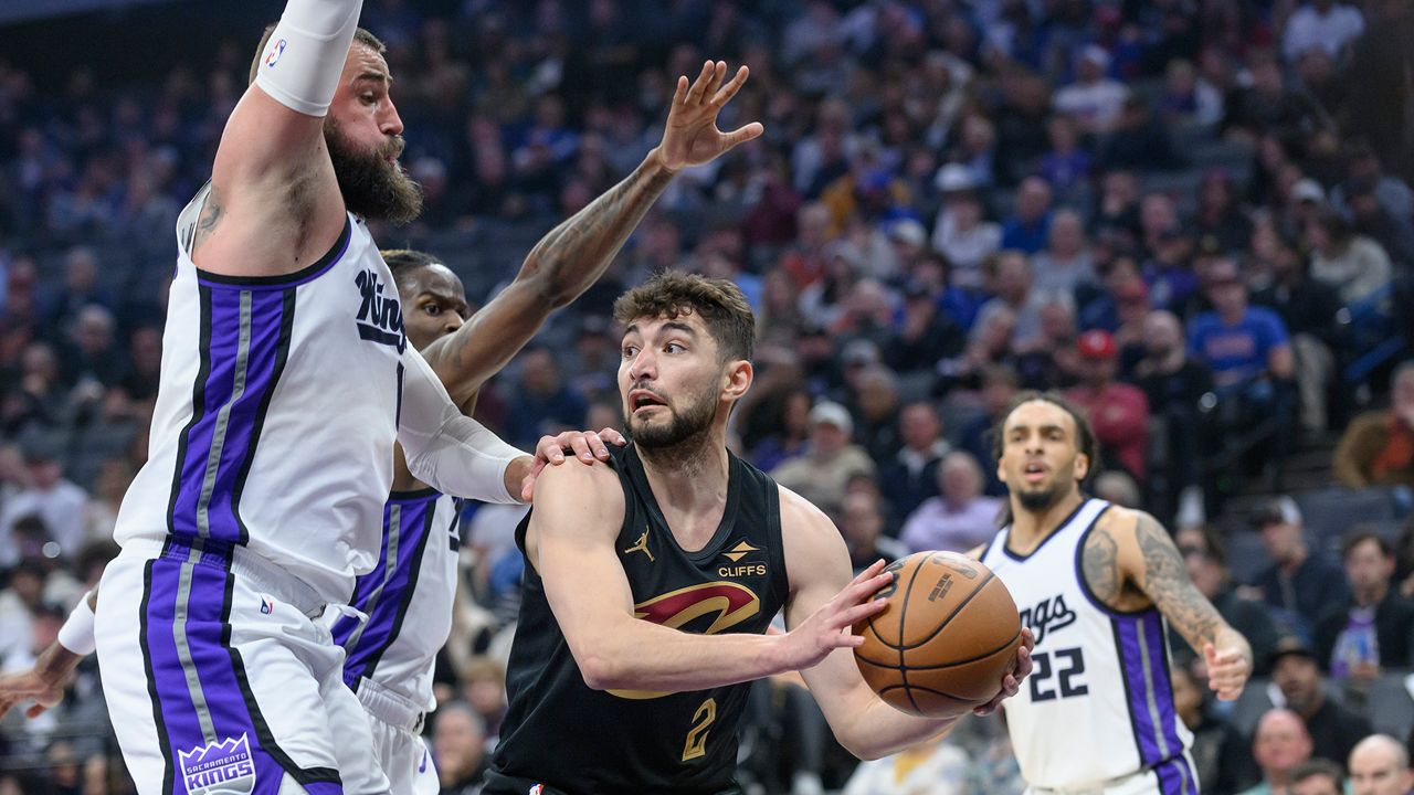 Cleveland Cavaliers guard Ty Jerome (2) is guarded by Sacramento Kings center Jonas Valanciunas, left, during the second half of an NBA basketball game in Sacramento, Calif., Wednesday, March 19, 2025. (AP Photo/Randall Benton)