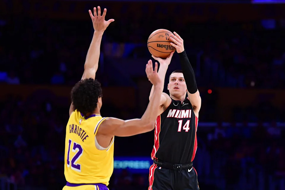 Jan 15, 2025; Los Angeles, California, USA; Miami Heat guard Tyler Herro (14) shoots against Los Angeles Lakers guard Max Christie (12) during the first half at Crypto.com Arena. Mandatory Credit: Gary A. Vasquez-Imagn Images