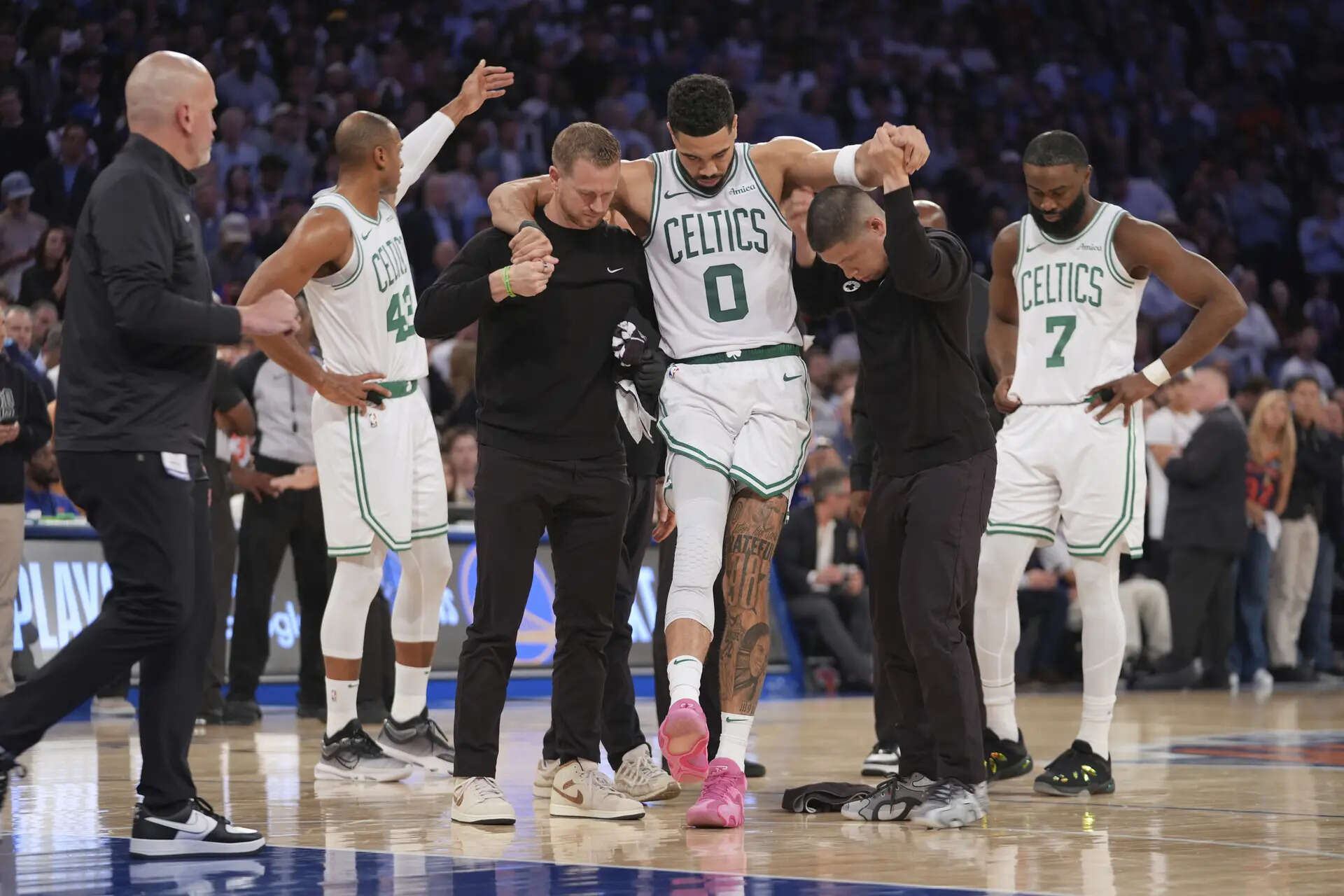 Trainers help Boston Celtics' Jayson Tatum (0) off the court after he was injured during the second half of Game 4 in the Eastern Conference semifinals of the NBA basketball playoffs against the New York Knicks, May 12, 2025, in New York. (AP Photo/Frank Franklin II, File) Celtics' Brad Stevens shuns idea team is in a rebuild with Jayson Tatum out