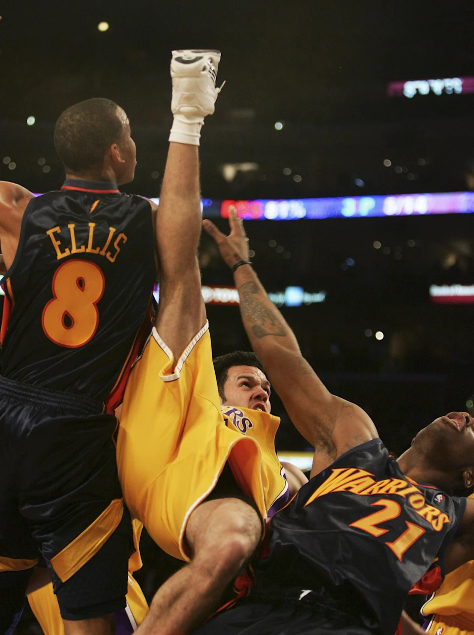 LOS ANGELES, CA - JANUARY 22: Jordan Farmer #5 of the Los Angeles Lakers falls on his back as he tries to go to the basket between Josh Powell #21 and Monta Ellis #8 of the Golden State Warriors in the second half of the game on January 22, 2007 at the Staples Center in Los Angeles, California. (Photo by Robert Laberge/Getty Images)