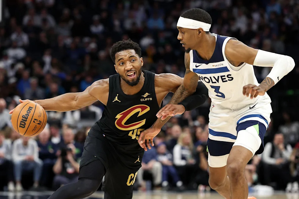 Jan 18, 2025; Minneapolis, Minnesota, USA; Cleveland Cavaliers guard Donovan Mitchell (45) works around Minnesota Timberwolves forward Jaden McDaniels (3) during the fourth quarter at Target Center. Mandatory Credit: Matt Krohn-Imagn Images