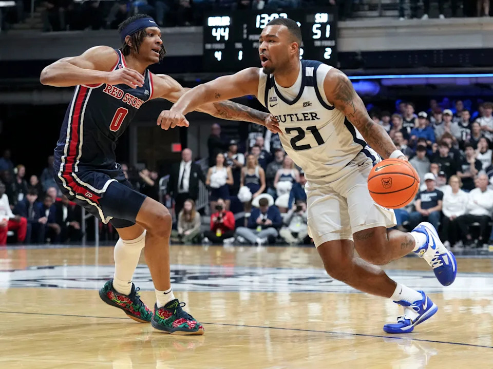 St. John's Red Storm guard Aaron Scott (0) guards Butler Bulldogs forward Pierre Brooks II (21) during the second half of a game Wednesday, Feb. 26, 2025, at Hinkle Fieldhouse in Indianapolis. St. John’s defeated Butler 76-70.