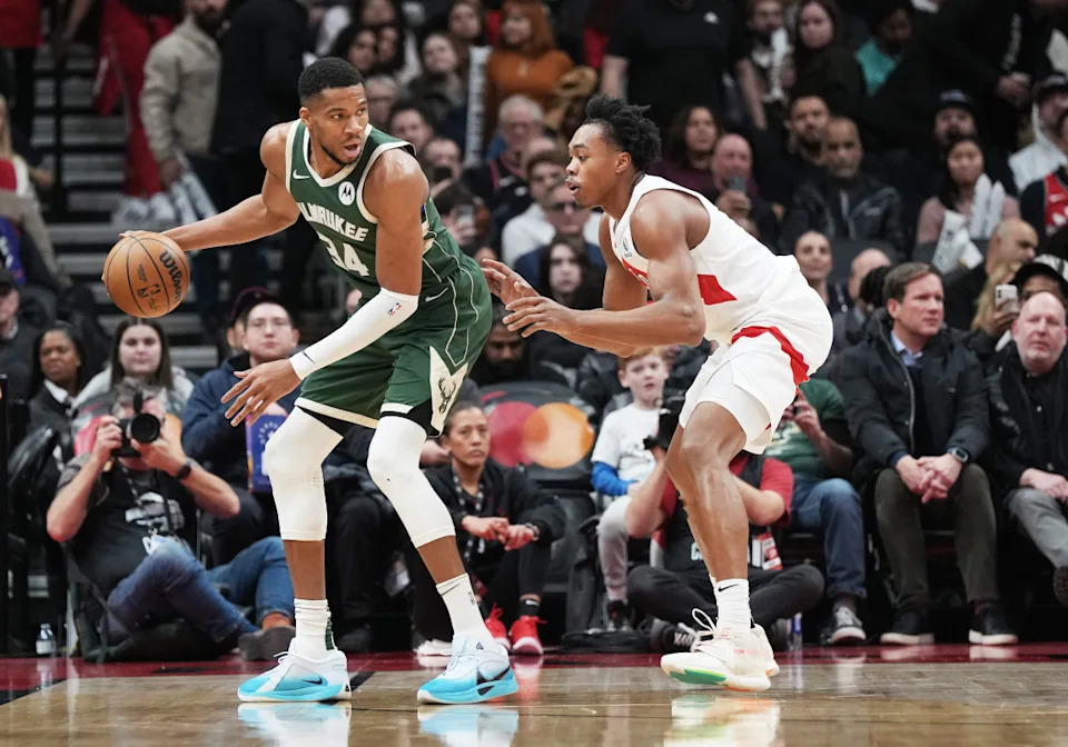 Milwaukee Bucks forward Giannis Antetokounmpo (34) controls the ball as Toronto Raptors forward Scottie Barnes (4) defendsNick Turchiaro-Imagn Images