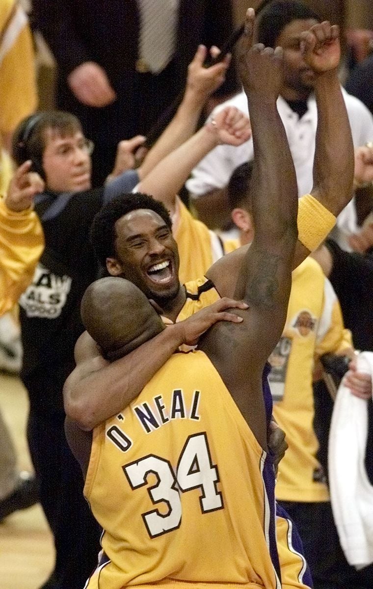  Kobe Bryant jumps into the arms of Shaquille O'Neal as the Los Angeles Lakers celebrate winning the NBA Championship, 19 June 2000.