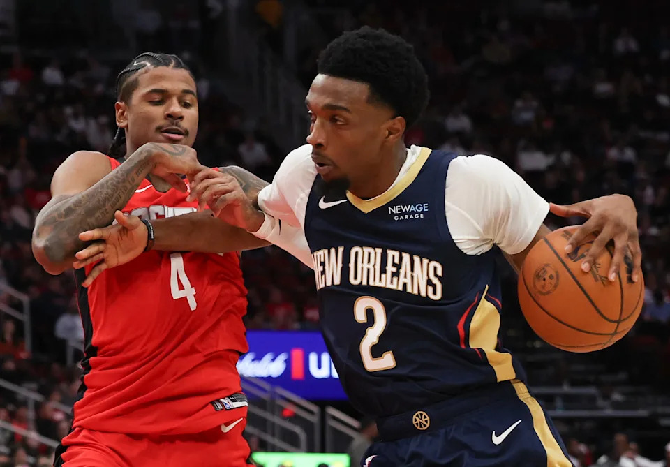 Dec 19, 2024; Houston, Texas, USA; New Orleans Pelicans forward Herbert Jones (2) drives against Houston Rockets guard Jalen Green (4) in the second quarter at Toyota Center. Mandatory Credit: Thomas Shea-Imagn Images