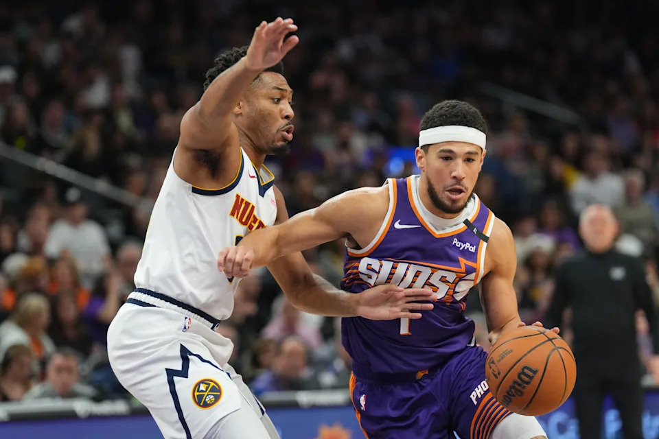 Feb 8, 2025; Phoenix, Arizona, USA; Phoenix Suns guard Devin Booker (1) drives against Denver Nuggets guard Jalen Pickett (24) during the first half at Footprint Center. Mandatory Credit: Joe Camporeale-Imagn Images
