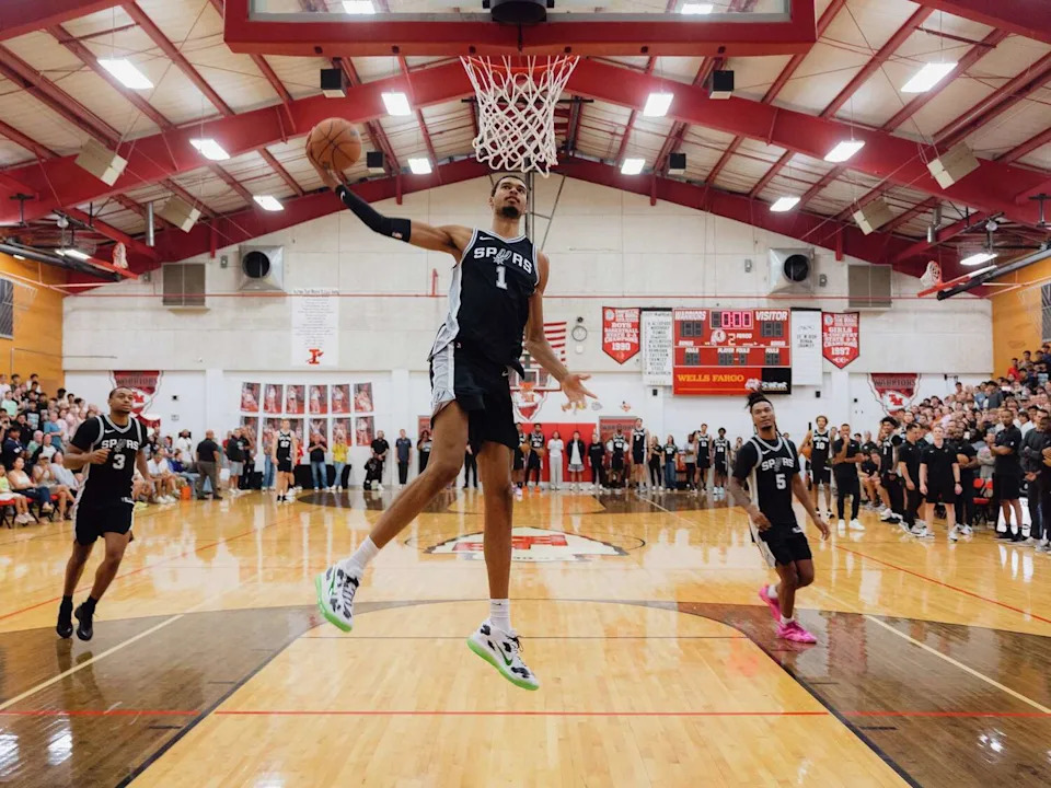 The San Antonio SpursÕ Victor Wembanyama performs a dunk for an audience of students at Ingram Tom Moore High School in Ingram on Wednesday, September 10, 2025. The Spurs put on a community event for the students of the middle and high schools to show support in the months after the deadly July 4 flood in Kerr County. (Christopher Lee/Staff Photographer)